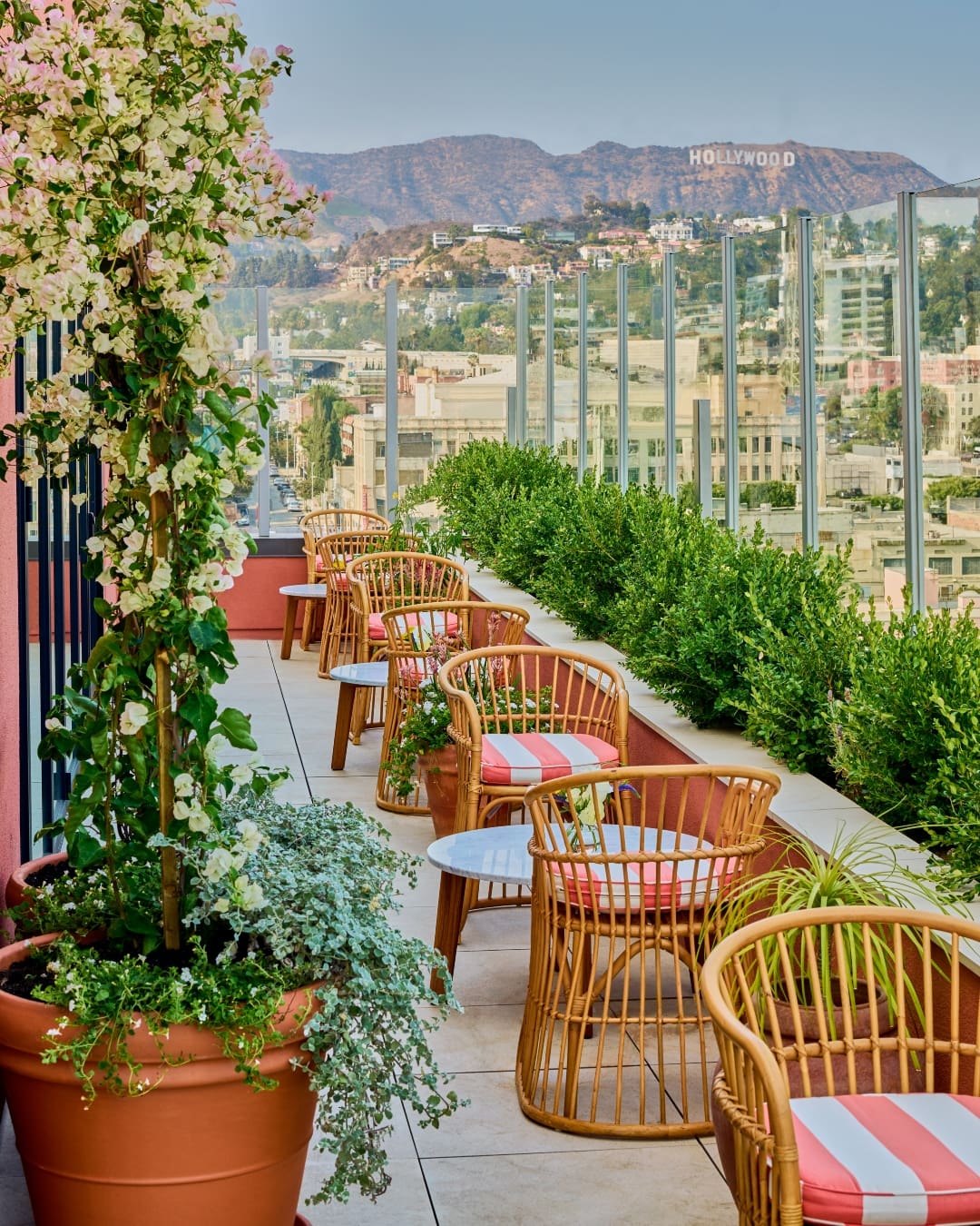 Pink striped chairs with Hollywood Hills views at Bar Lis