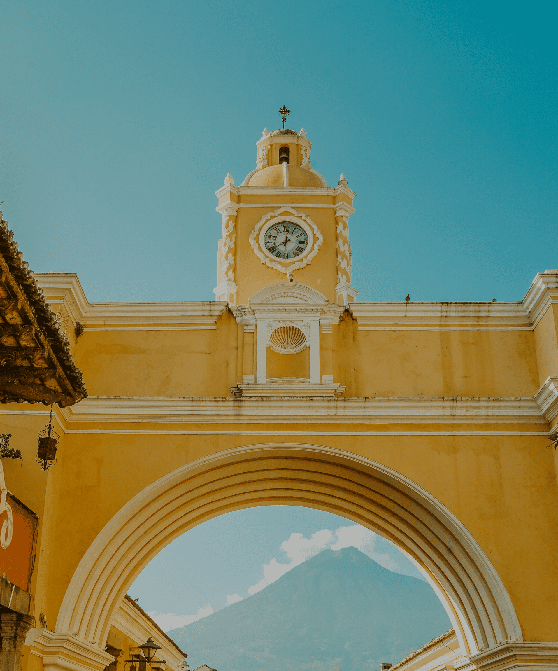 a gold-tone building beneath a blue sky in Antigua Guatemala