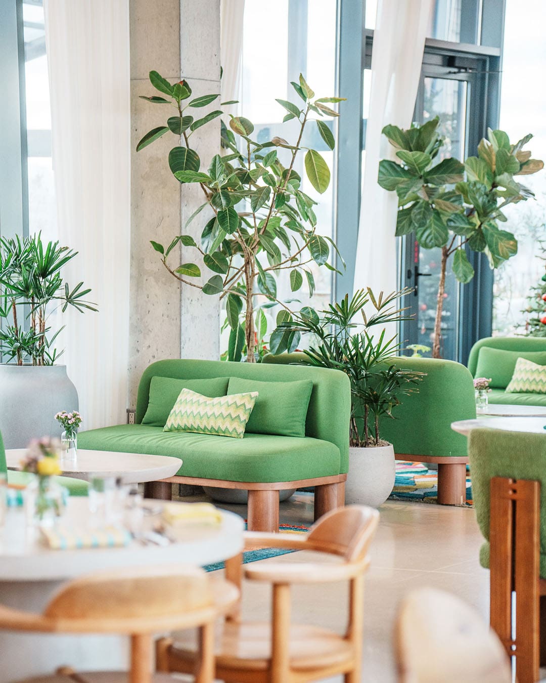 A sofa and chairs in a calming space at elNico at Penny Williamsburg hotel in Brooklyn