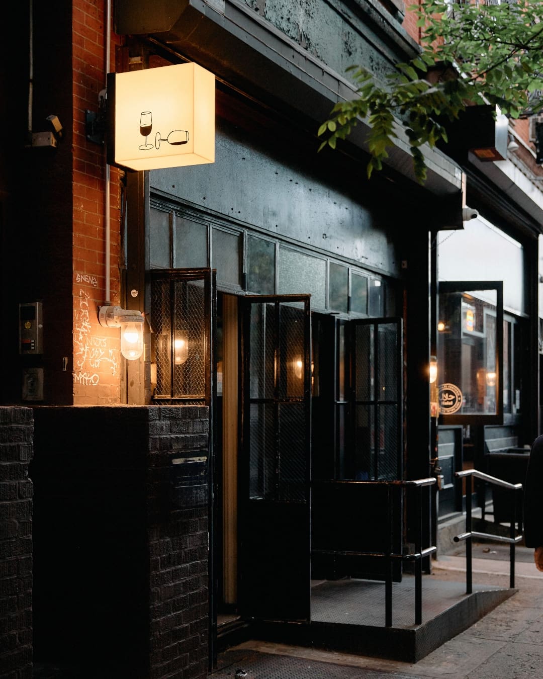 The dark exterior of With Others, with prime location in Williamsburg