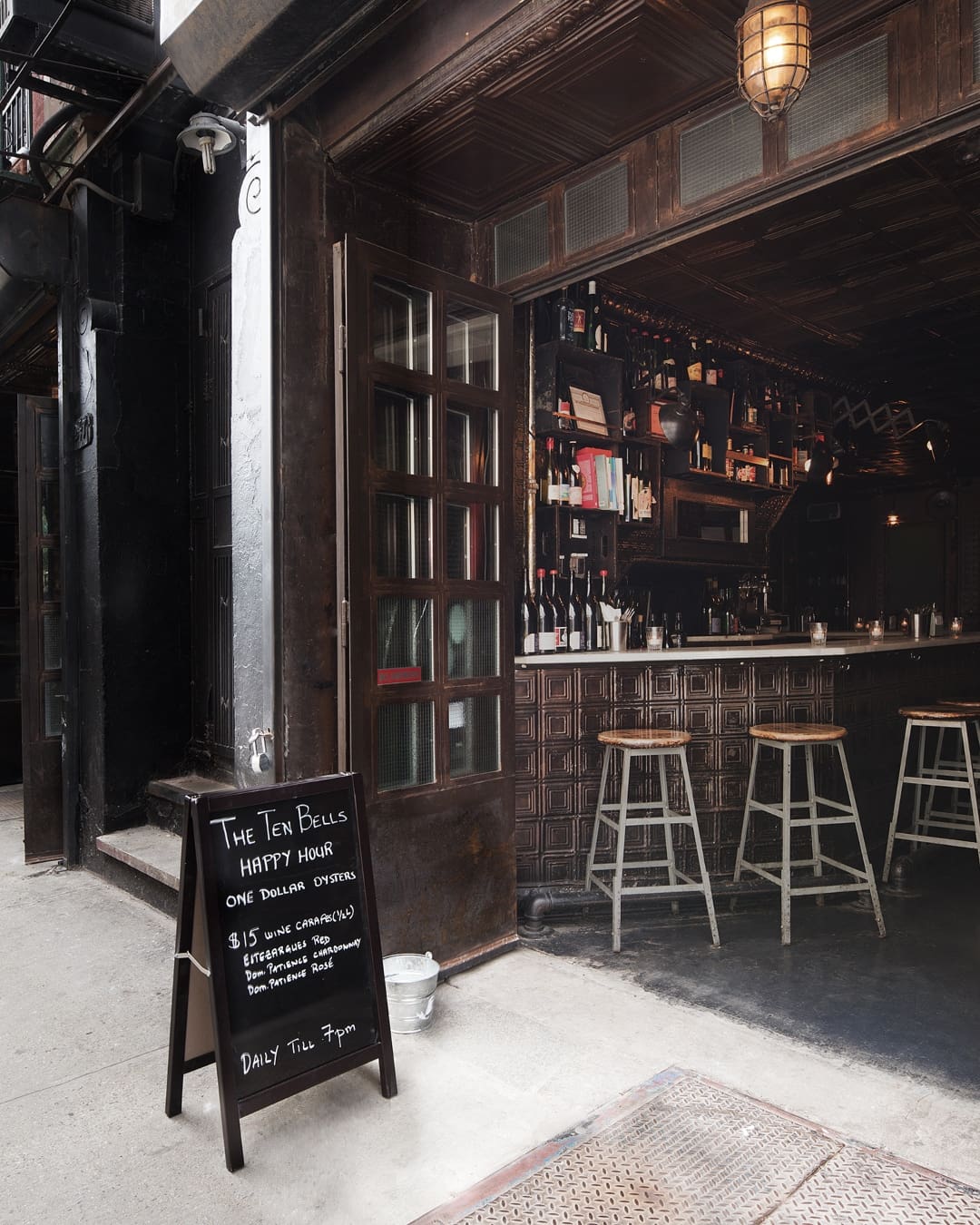 Outside The Ten Bells in New York, looking into the dark wooden bar