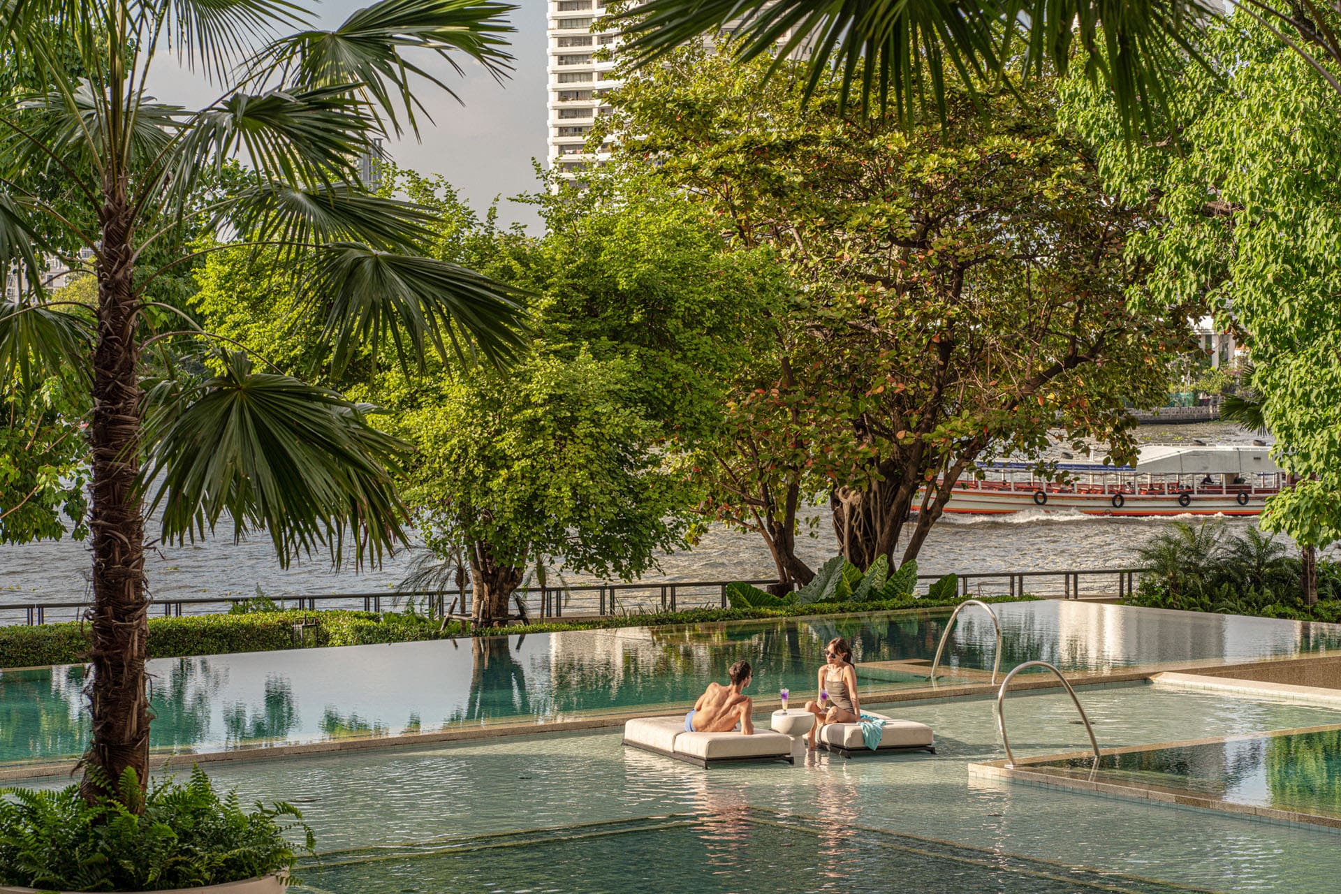 View of terraced pools and trees toward the Chao Phraya river at Four Seasons hotel in Bangkok