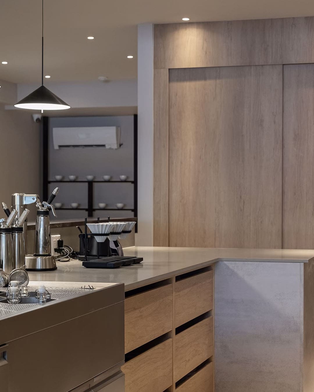 The modern wooden interior of Three Dots Coffee Lab with coffee machines and countertops