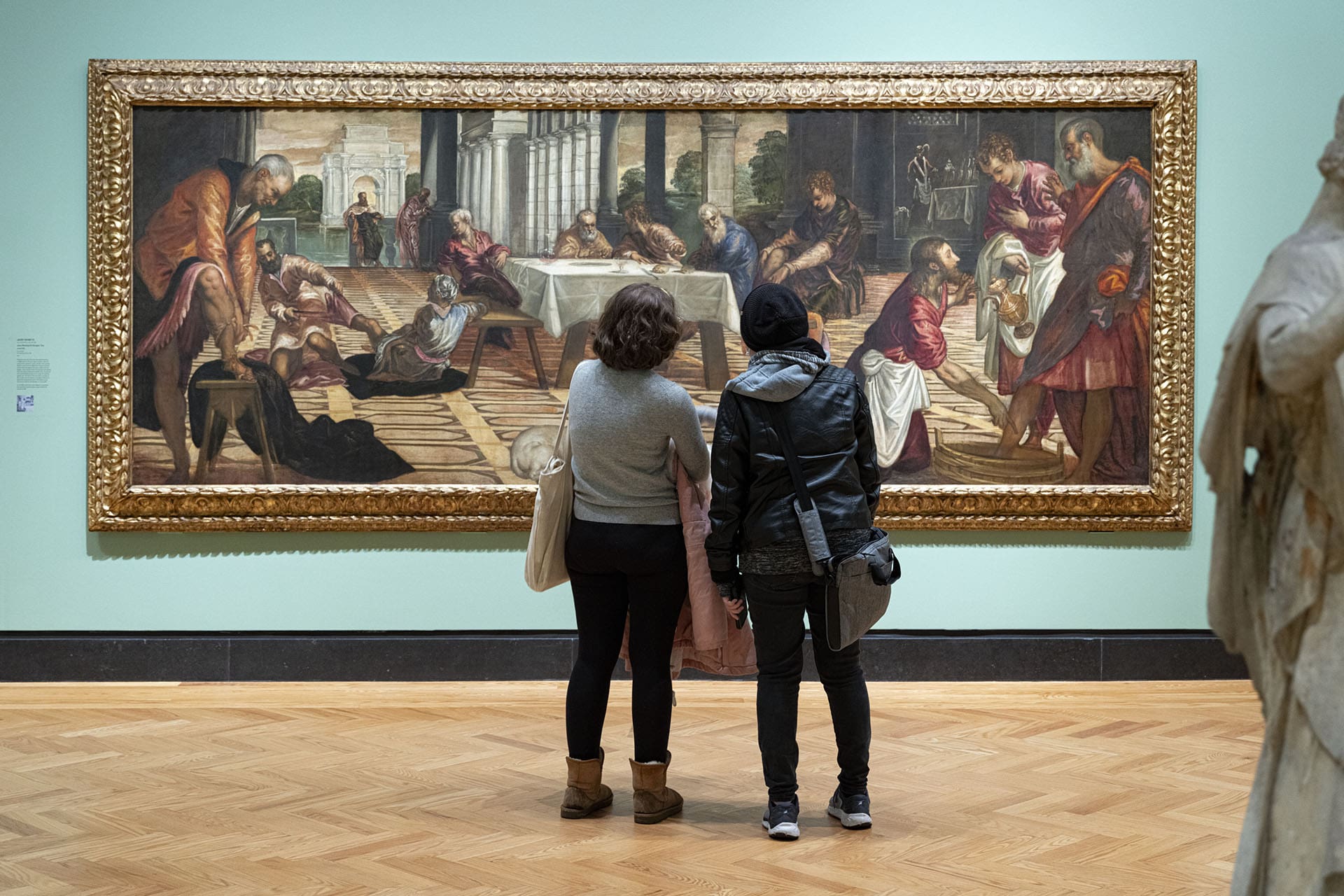Visitors stand in front of one of the Art Gallery of Ontario's paintings