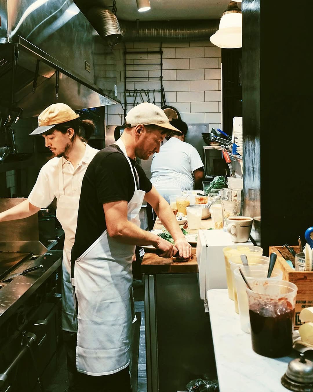 Chefs and sous chefs prepare meals in a kitchen at Union