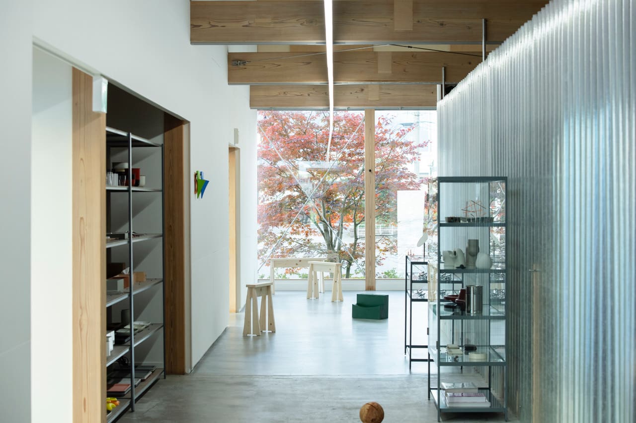 ataW lifestyle store with a pink blossom tree in view out the window. Photography by Kyoko Kataoka