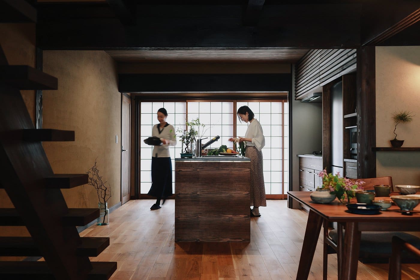 An atmospheric Japanese guesthouse with woman preparing food