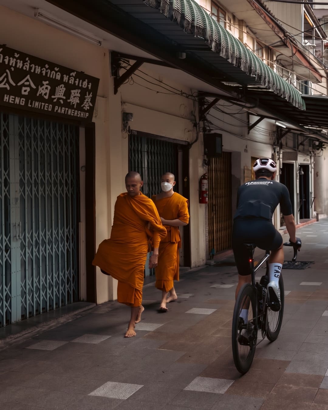 Riding through Bangkok at dawn passed monks in saffron robes