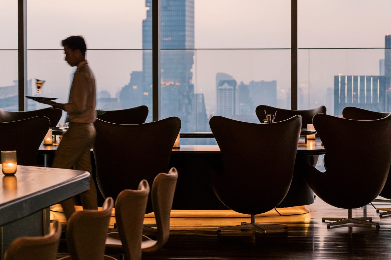 A bartender at The Norm beside Friz Hansen chairs