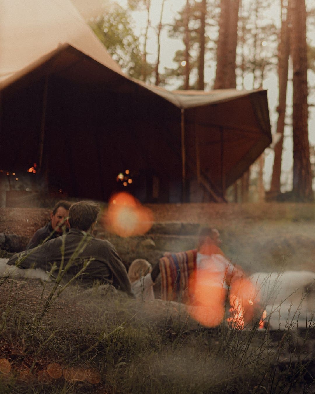 Guests outside the tipi at The Dell of Abernethy in the Scottish Highlands